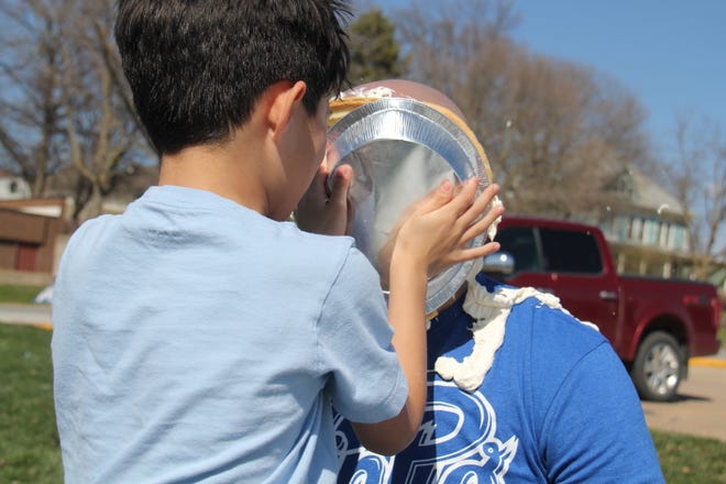 Cain Lott, 8, get set to throw a pie in the face of Alex Lott during the Grand Finale of the Big Boom Bracket Battle on Monday, April 8, 2024.
