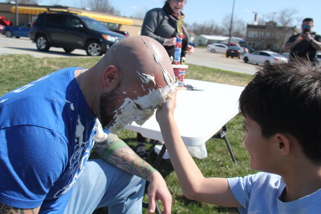 Cain Lott wipes pie off the face of his father, Alex Lott, during the Grand Finale of the Big Boom Bracket Battle on Monday, April 8, 2024.