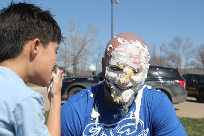 Cain Lott tastes the banana cream pie after throwing it in the face of Alex Lott during the Grand Finale of the Big Boom Bracket Battle on Monday, April 8, 2024.
