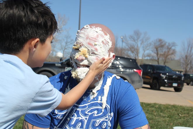 Cain Lott gets set to taste the banana cream pie after throwing it in the face of Alex Lott during the Grand Finale of the Big Boom Bracket Battle on Monday, April 8, 2024.