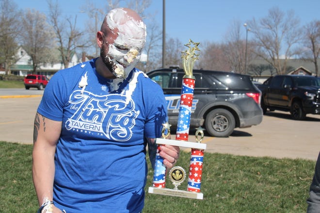 Alex Lott holds up the Big Boom Bracket Battle Trophy during the grand finale on Monday, April 8, 2024.
