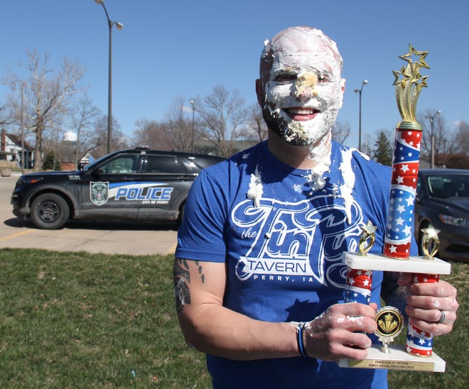Alex Lott, with the Perry Police Department, poses for a photo with the Big Boom Bracket Battle Trophy during the grand finale on Monday, April 8, 2024.
