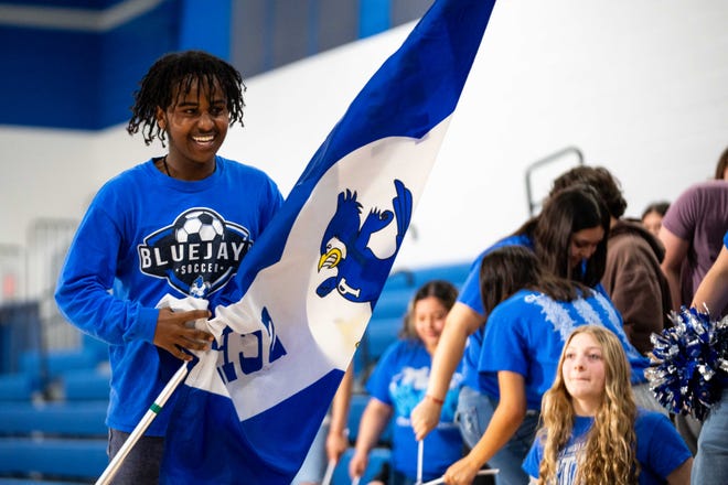 Perry senior Maebel Tekle runs a flag down the stands during a filming session for "Good Morning America" Friday, April 12, 2024, at Perry High School. The junior and senior classes at Perry were awarded $50,000 by JCPenney for their "Dream Prom."