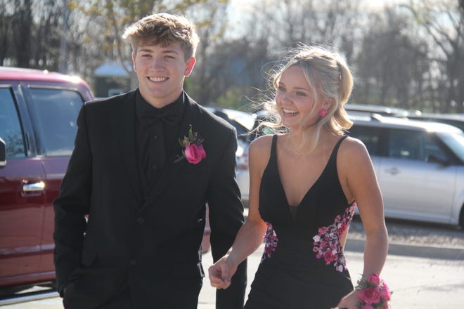 Oliver Potter and Darcy Allen head into the high school for the prom grand march on Friday, April 19, 2024.