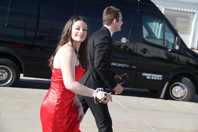 Emma Brighton and Jacob Phipps head into the high school for the prom grand march on Friday, April 19, 2024.
