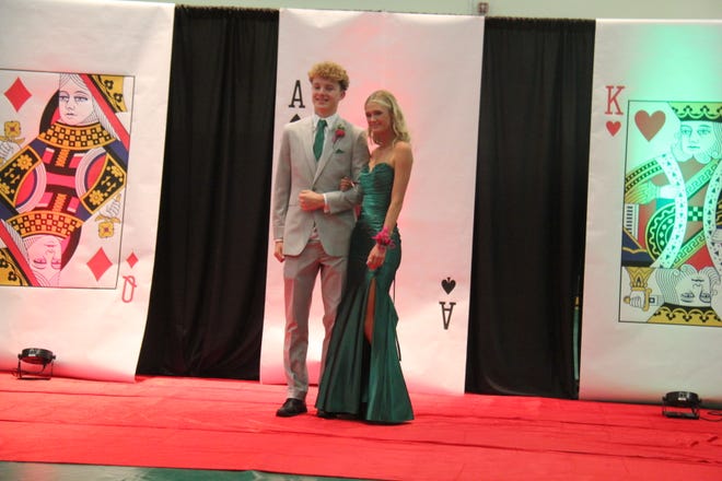 Bryan Jesse and Taylor Condon pose for photos during the prom grand march on Friday, April 19, 2024, in the Woodward-Granger High School gym.