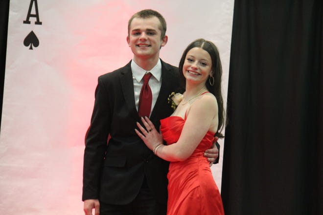 Jacob Phipps and Emma Brighton pose for photos during the prom grand march on Friday, April 19, 2024, in the Woodward-Granger High School gym.