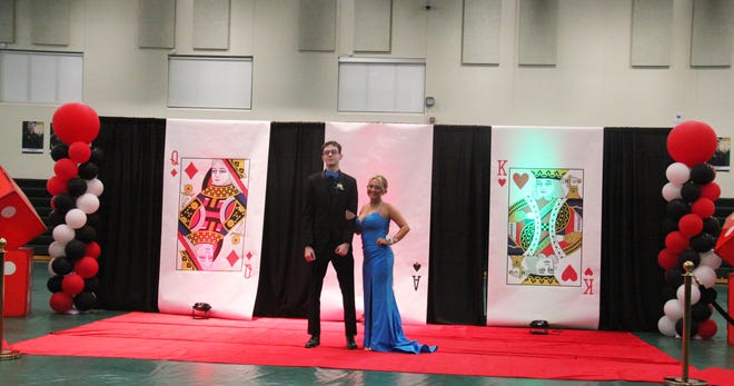 Jake Hultman and Ella Bearbower pose for photos during the prom grand march on Friday, April 19, 2024, in the Woodward-Granger High School gym.