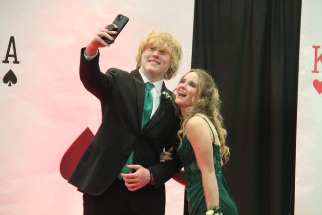 Taylor Headley and Danika Leuenberger take a selfie during the prom grand march on Friday, April 19, 2024, in the Woodward-Granger High School gym.