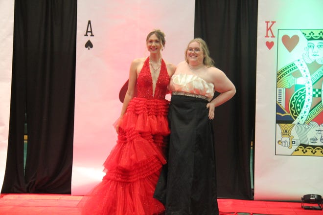 Abby Rosen and Katherine Meusburger pose for photos during the prom grand march on Friday, April 19, 2024, in the Woodward-Granger High School gym.