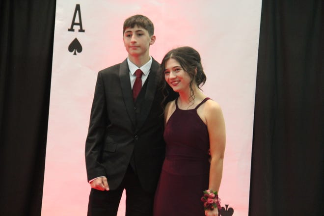 Daryn Brown and Kayley Reed pose for photos during the prom grand march on Friday, April 19, 2024, in the Woodward-Granger High School gym.