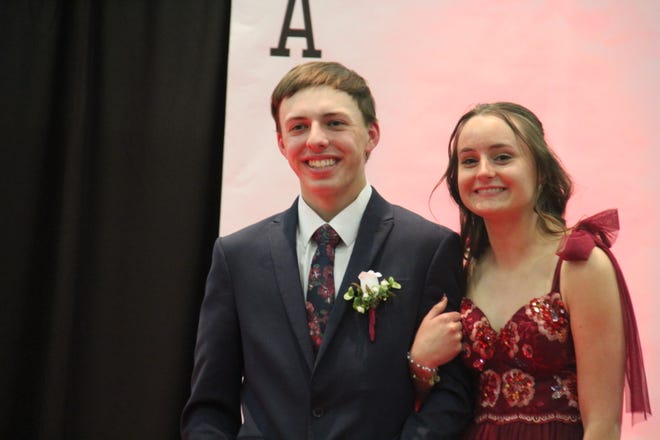 Sterling Parkinson and Maya Martin pose for photos during the prom grand march on Friday, April 19, 2024, in the Woodward-Granger High School gym.