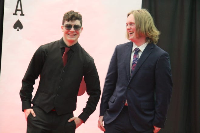 In no order, Greyson Mehrhoff and Tyler Clark pose for photos during the prom grand march on Friday, April 19, 2024, in the Woodward-Granger High School gym.