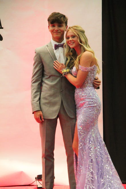 Shaefer Hanson and Jocelyn Bowlsby pose for photos during the prom grand march on Friday, April 19, 2024, in the Woodward-Granger High School gym.