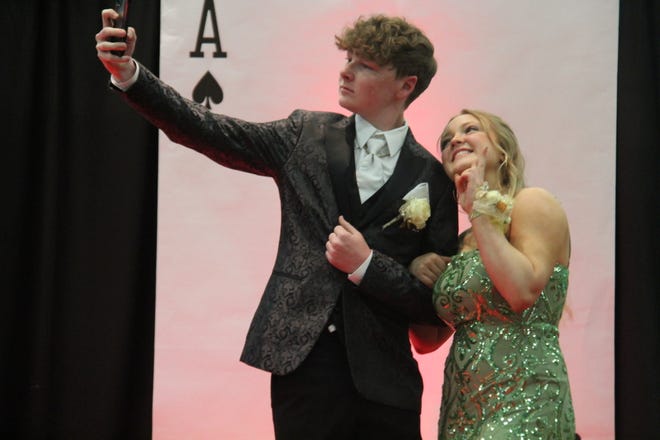 Casey Foster Haley Hollingsworth take a selfie during the prom grand march on Friday, April 19, 2024, in the Woodward-Granger High School gym.