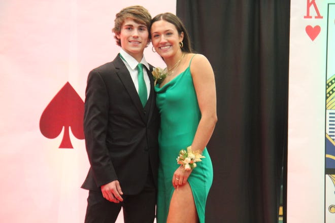 James Dorrian and Emalee Brown pose for photos during the prom grand march on Friday, April 19, 2024, in the Woodward-Granger High School gym.