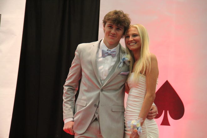 Landon Chambers and Ashleigh Buss pose for photos during the prom grand march on Friday, April 19, 2024, in the Woodward-Granger High School gym.