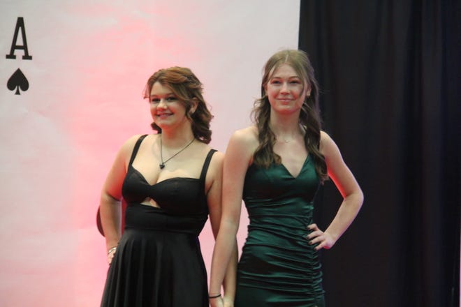In no order, Madison Hiner and Kennedy Thoma pose for photos during the prom grand march on Friday, April 19, 2024, in the Woodward-Granger High School gym.