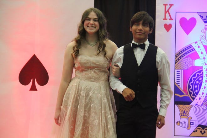 Claire Praska and Samuel Downing pose for photos during the prom grand march on Friday, April 19, 2024, in the Woodward-Granger High School gym.