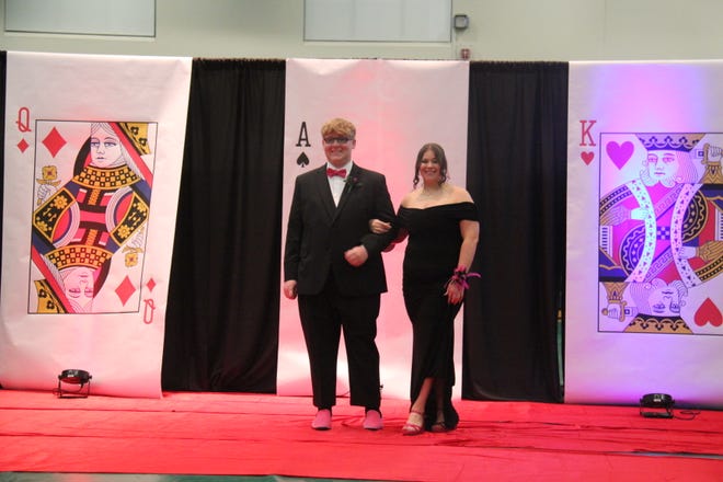 Garrett Hansen and Abbie Davis pose for photos during the prom grand march on Friday, April 19, 2024, in the Woodward-Granger High School gym.