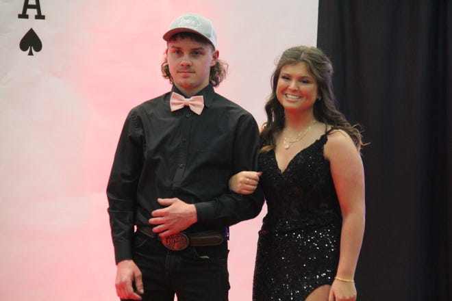 Marcus Watznauer and Maddie Rodgers pose for photos during the prom grand march on Friday, April 19, 2024, in the Woodward-Granger High School gym.