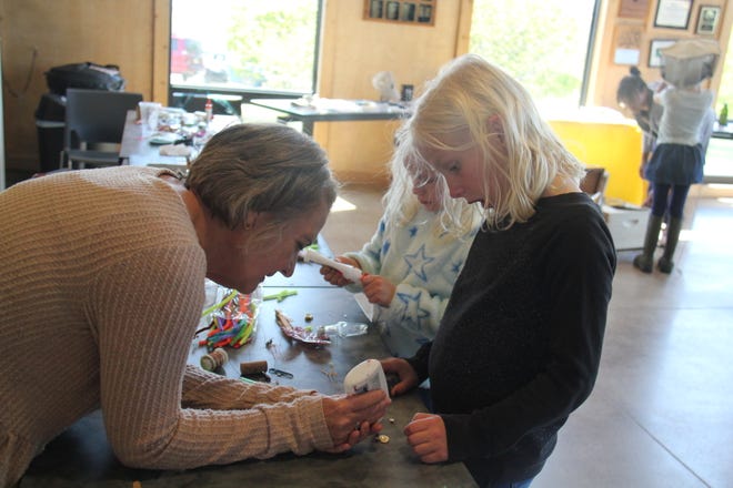 Jill Woodward helps kids create bugs out of found objects during The Brenton Arboretum's Earth Day Celebration on Sunday, April 21, 2024, near Dallas Center.