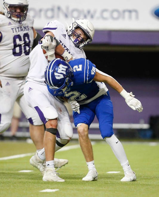 Van Meter senior safety Alex Jones hits South Central Calhoun junior running back Blake McAlister in the third quarter of their Class 1A game at the UNI-Dome in Cedar Falls on Saturday, Nov. 14, 2020.