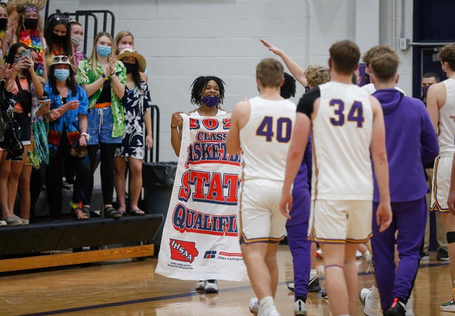 Members of the Waukee boys basketball team celebrate a 74-54 win over Ankeny during the Class 4A regional final on Tuesday, March 2, 2021.