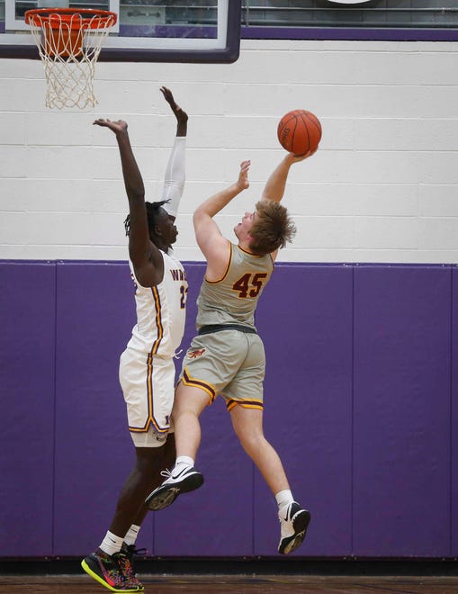 Ankeny junior forward Braden Simonsen puts up a shot over Waukee sophomore Omaha Biliew in the first quarter during the Class 4A regional final on Tuesday, March 2, 2021.
