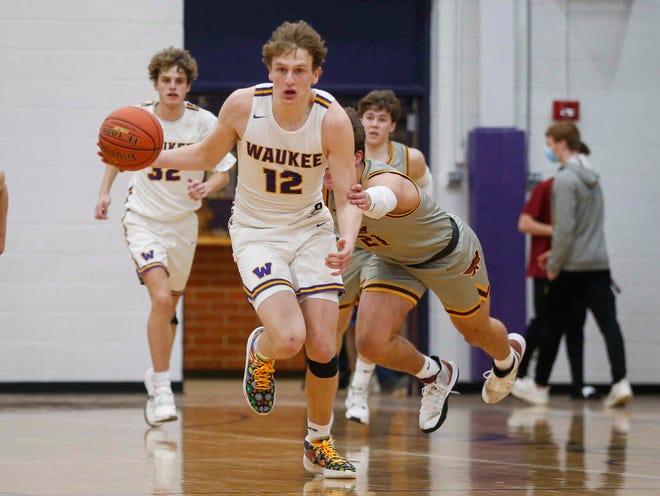 Waukee senior guard Tucker DeVries is fouled by Ankeny junior Ryan Crandall in the third quarter during the Class 4A regional final on Tuesday, March 2, 2021.