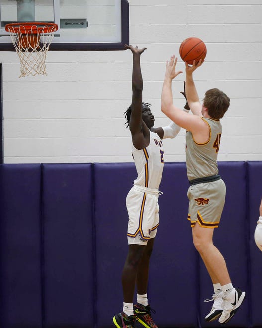 Ankeny junior forward Braden Simonsen puts up a shot over Waukee sophomore Omaha Biliew in the first quarter during the Class 4A regional final on Tuesday, March 2, 2021.