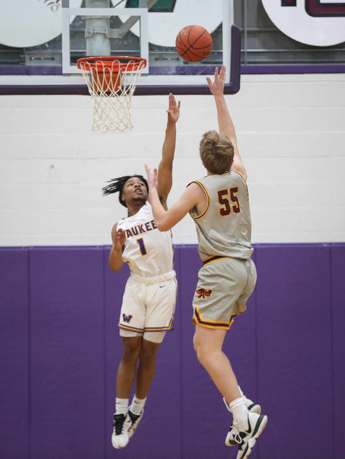 Ankeny sophomore forward JJ Kohl lifts a shot up over Waukee senior guard Malik Allen in the fourth quarter during the Class 4A regional final on Tuesday, March 2, 2021.