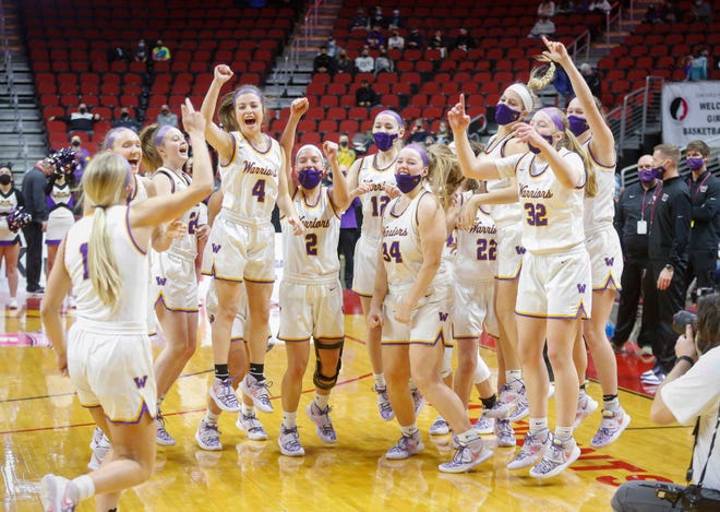 Members of the Waukee girls basketball team celebrate a win over Ankeny Centennial on Thursday, March 4, 2021, during the Iowa high school girls state basketball tournament at Wells Fargo Arena in Des Moines.