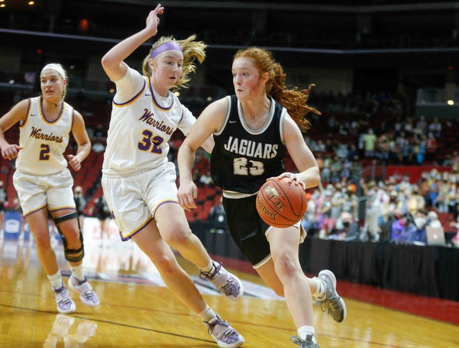 Ankeny Centennial senior Maggie Phipps drives the ball around the defense of Waukee junior guard Reagan Bartholomew in the first quarter on Thursday, March 4, 2021, during the Iowa high school girls state basketball tournament at Wells Fargo Arena in Des Moines.