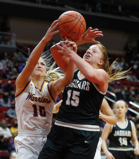 Waukee senior guard Katie Dinnebier, left, and Ankeny Centennial senior Jackie Pippett fight for a rebound in the first quarter on Thursday, March 4, 2021, during the Iowa high school girls state basketball tournament at Wells Fargo Arena in Des Moines.