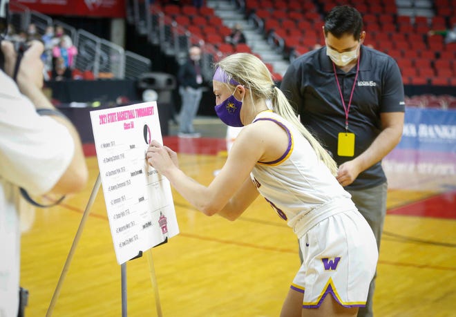 Waukee senior guard Katie Dinnebier updates the bracket after the Warriors beat Ankeny Centennial in their Class 5A game on Thursday, March 4, 2021, during the Iowa high school girls state basketball tournament at Wells Fargo Arena in Des Moines.