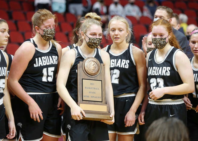 Members of the Ankeny Centennial girls basketball team accept the state semifinalist trophy after losing to Waukee in their Class 5A game on Thursday, March 4, 2021, during the Iowa high school girls state basketball tournament at Wells Fargo Arena in Des Moines.