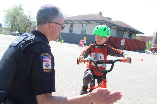 Officer Monte Keller explains the rules of the road during the 2019 Safety Bike Rodeo.
